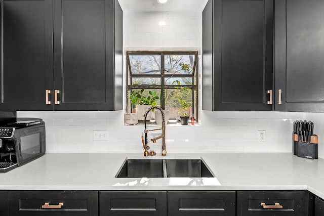 kitchen with tasteful backsplash and sink