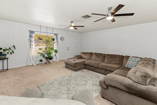 carpeted living room with ceiling fan and a textured ceiling