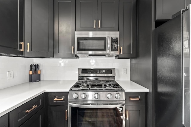 kitchen with appliances with stainless steel finishes and tasteful backsplash