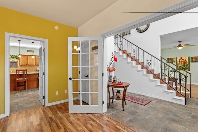 interior space featuring lofted ceiling, baseboards, and wood finished floors