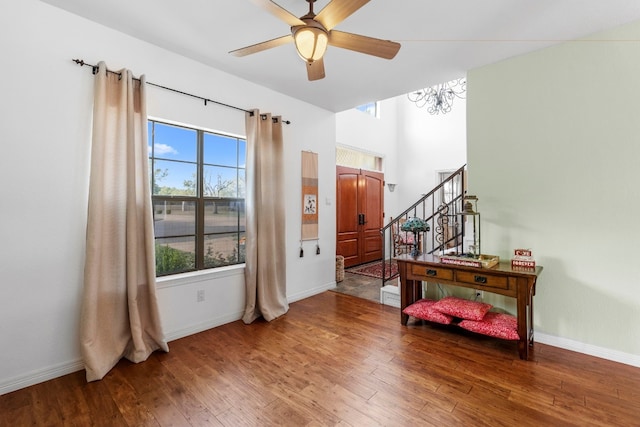 interior space featuring stairs, baseboards, and hardwood / wood-style floors