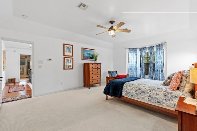 carpeted bedroom with visible vents and ceiling fan