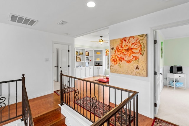 corridor featuring recessed lighting, visible vents, wood finished floors, and an upstairs landing