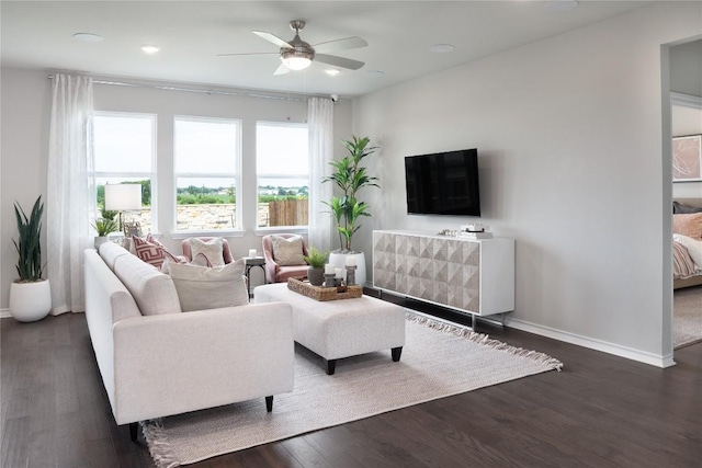 living room with ceiling fan and dark wood-type flooring