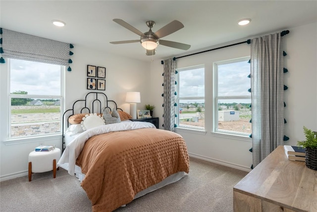 bedroom featuring light colored carpet and ceiling fan