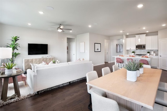 dining room with dark hardwood / wood-style flooring and ceiling fan