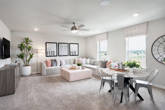 living room with ceiling fan and light colored carpet