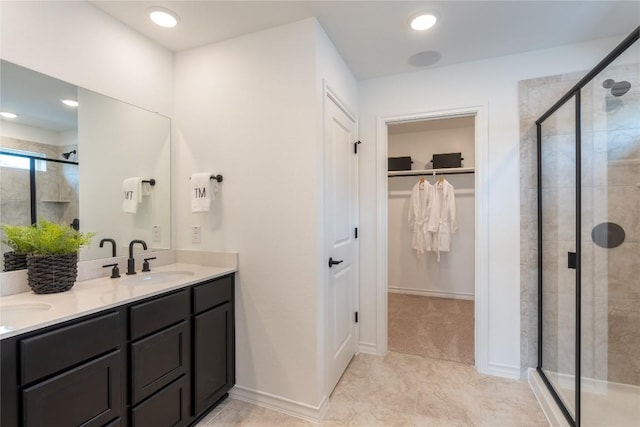 bathroom featuring tile patterned floors, vanity, and a shower with shower door