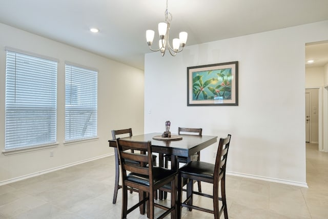 dining space featuring light tile patterned floors and a notable chandelier