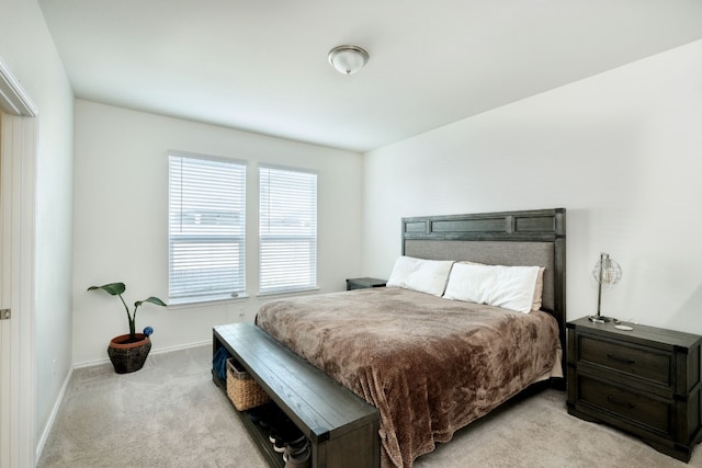 bedroom featuring light colored carpet