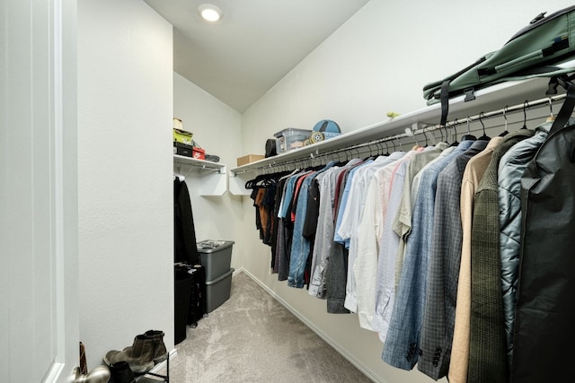 spacious closet featuring light carpet and vaulted ceiling