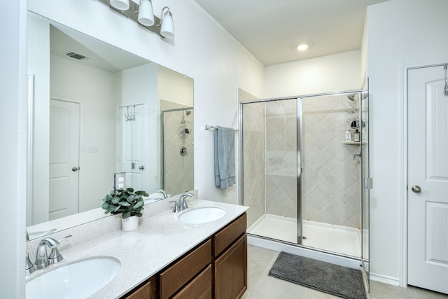 bathroom featuring vanity, tile patterned floors, and an enclosed shower