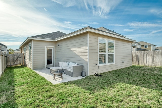 rear view of property featuring a lawn, a patio area, and an outdoor living space