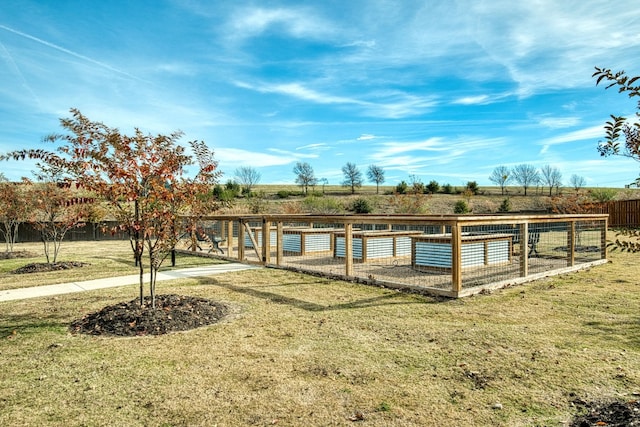 view of dock featuring a rural view and a lawn