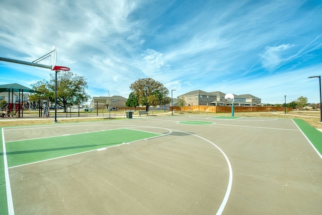 view of basketball court featuring a playground