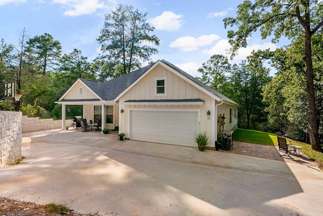 view of front of property featuring a patio and a garage