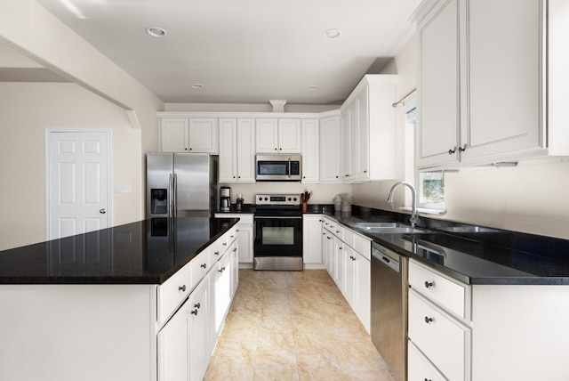 kitchen with white cabinets, sink, and appliances with stainless steel finishes