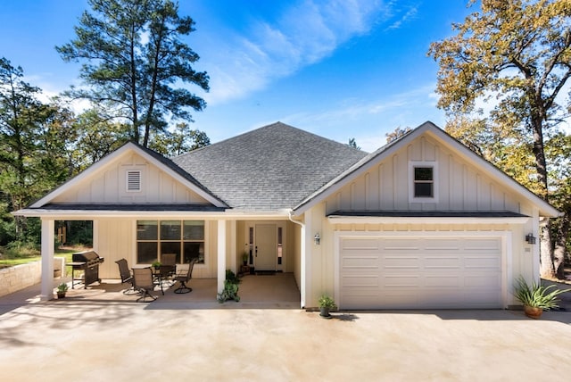 view of front of house with a garage and a patio area