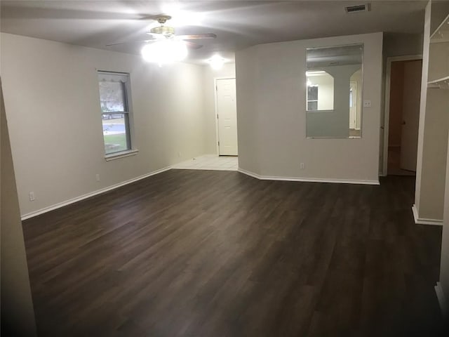 empty room featuring dark hardwood / wood-style flooring and ceiling fan