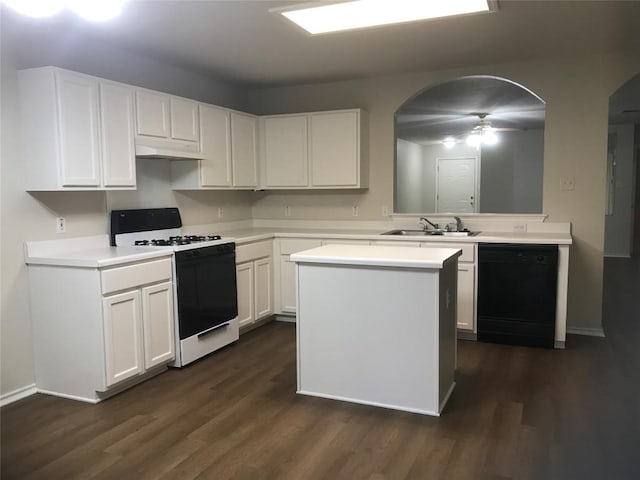 kitchen featuring white range with gas cooktop, dishwasher, white cabinets, and dark wood-type flooring