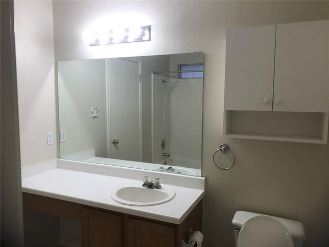 full bathroom with shower / tub combination, vanity, and toilet