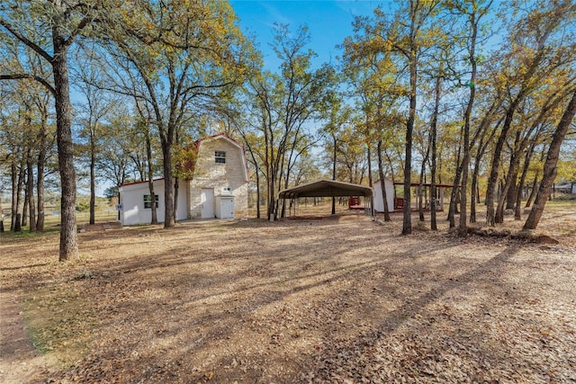 120 Laguna, Smithville, TX 78957 - view of yard with a detached carport, driveway, and an outbuilding