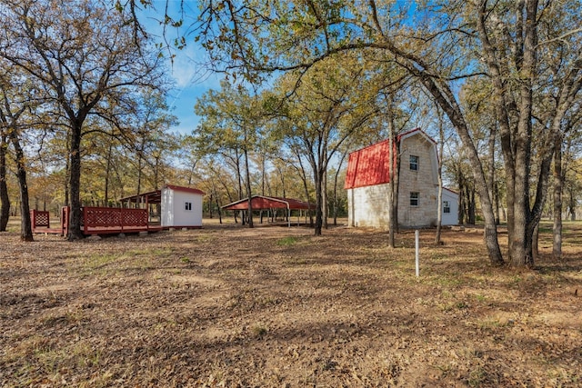 view of yard featuring an outbuilding and a carport