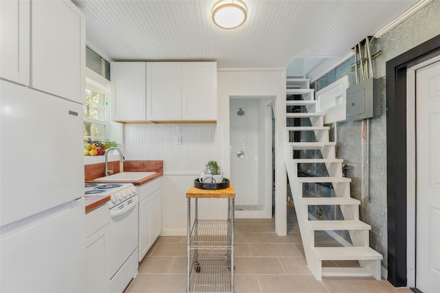 kitchen featuring ornamental molding, white appliances, sink, white cabinets, and light tile patterned flooring