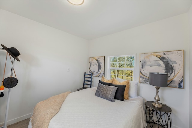 120 Laguna, Smithville, TX 78957 - bedroom featuring baseboards and wood finished floors