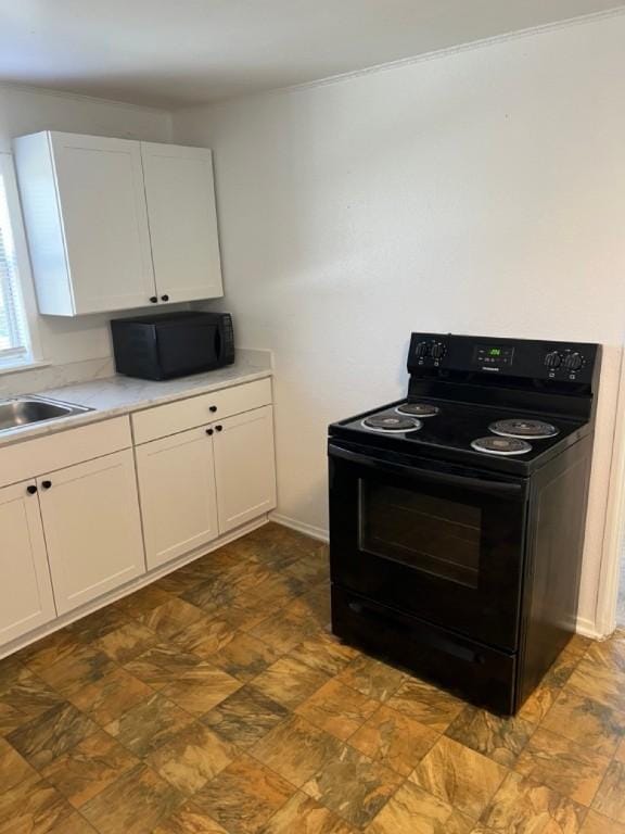 kitchen with white cabinetry, sink, and black appliances