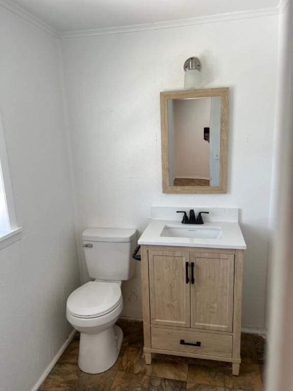 bathroom featuring vanity, toilet, and ornamental molding