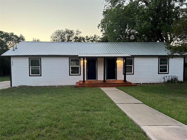 ranch-style home with a yard