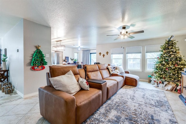 tiled living room with a textured ceiling and ceiling fan