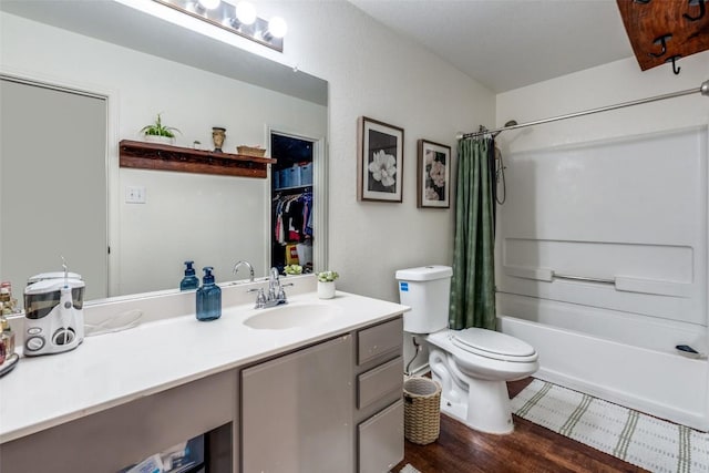 full bathroom featuring hardwood / wood-style floors, vanity, toilet, and shower / tub combo with curtain