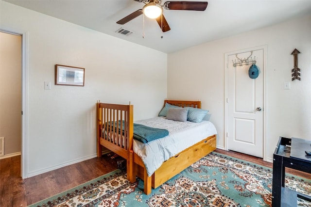 bedroom featuring dark hardwood / wood-style flooring and ceiling fan