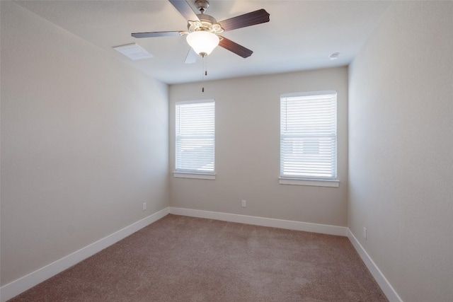 carpeted spare room featuring ceiling fan