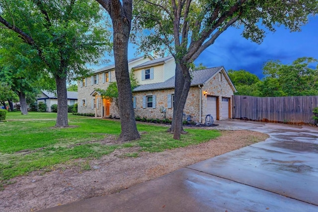 12323 Blue Water Dr, Austin, TX 78758 - view of front of house featuring stone siding, concrete driveway, and an attached garage