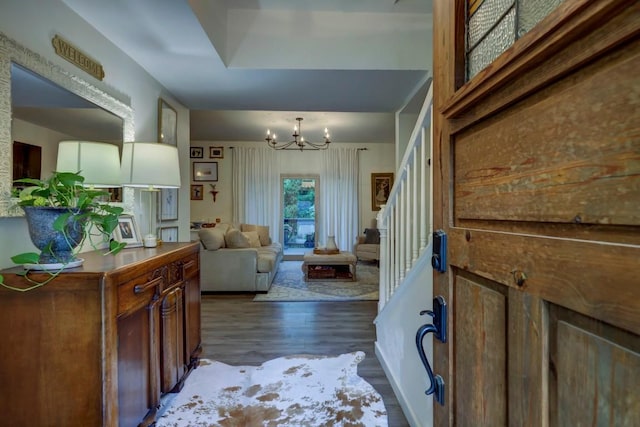 12323 Blue Water Dr, Austin, TX 78758 - foyer entrance with dark wood-style floors, a chandelier, and stairway