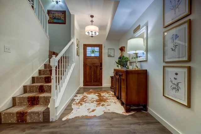 entryway featuring hardwood / wood-style flooring and a notable chandelier