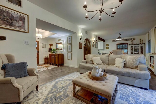 12323 Blue Water Dr, Austin, TX 78758 - living room with a chandelier and wood finished floors