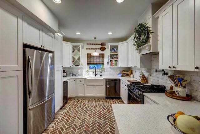 kitchen with decorative backsplash, light stone counters, black appliances, pendant lighting, and white cabinetry