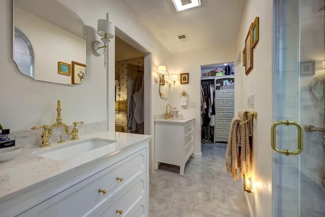 12323 Blue Water Dr, Austin, TX 78758 - full bath featuring two vanities, a shower stall, and a spacious closet