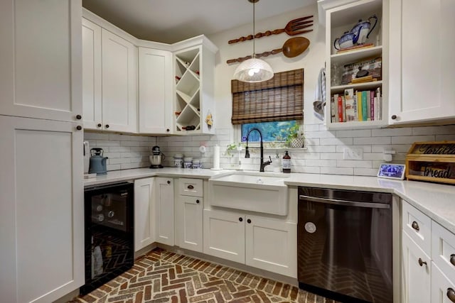 kitchen featuring white cabinets, beverage cooler, sink, pendant lighting, and dishwasher