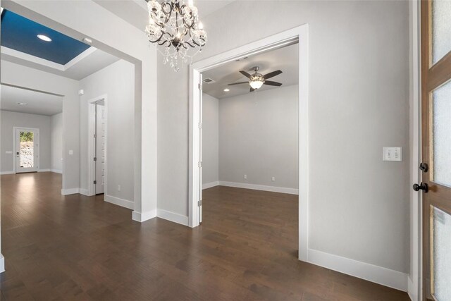 entryway featuring dark wood-type flooring and ceiling fan with notable chandelier