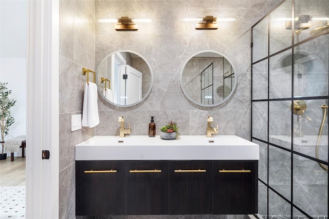 bathroom featuring vanity and tile walls