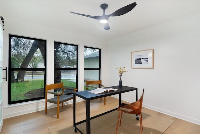 home office with ceiling fan and light wood-type flooring