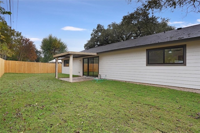 rear view of property featuring a patio and a lawn