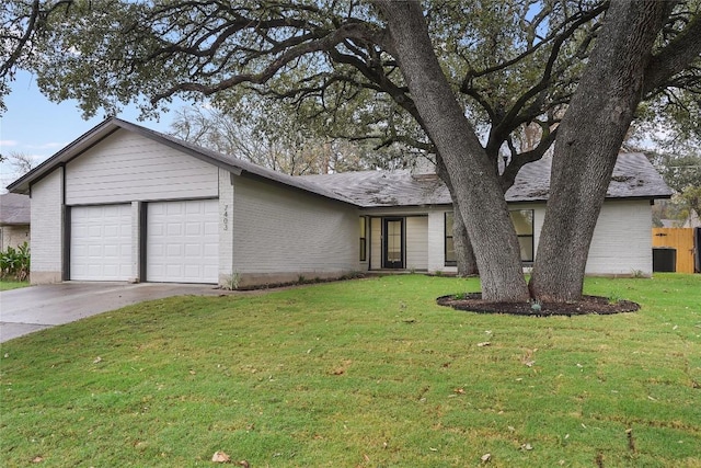 ranch-style house with a garage and a front yard