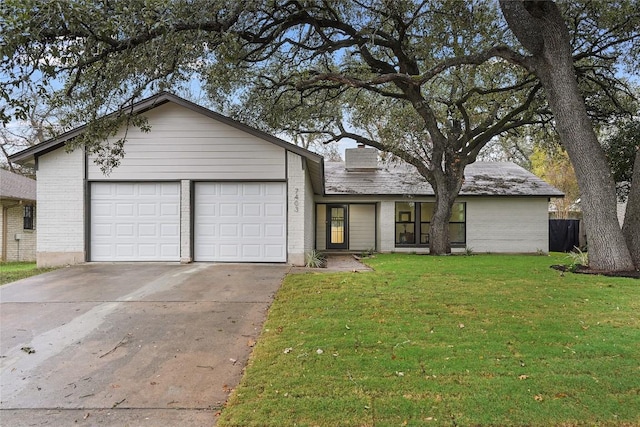 ranch-style home featuring a front lawn and a garage