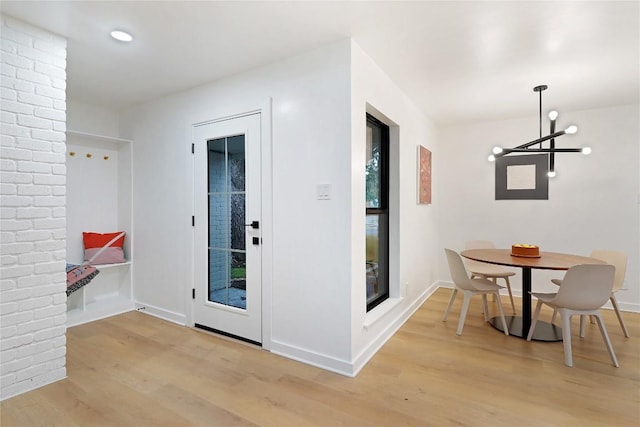 interior space with an inviting chandelier and light hardwood / wood-style floors